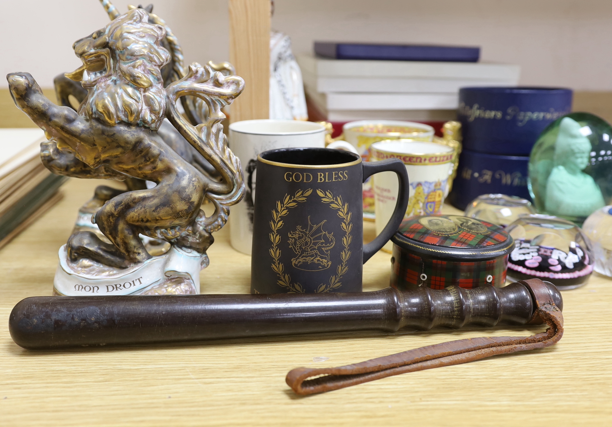 A collection of principally Victorian and later commemorative wares to include a pair of Wedgwood porcelain armorial beasts, glass paperweights etc together with a constabulary truncheon, the largest 39cm in length